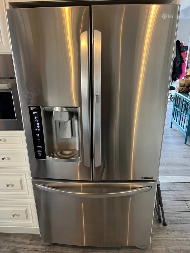 A kitchen scene with a technician working on an appliance, demonstrating professional service and repair.